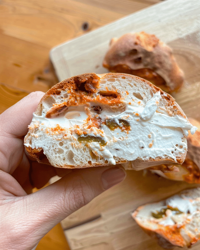 Easy Jalapeño Cheddar Sourdough Bagels with a Crispy Golden Crust 20 jalapeño cheddar sourdough bagel sliced and topped with cream